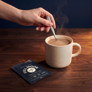 Stirring one sachet into a mug of warm milk