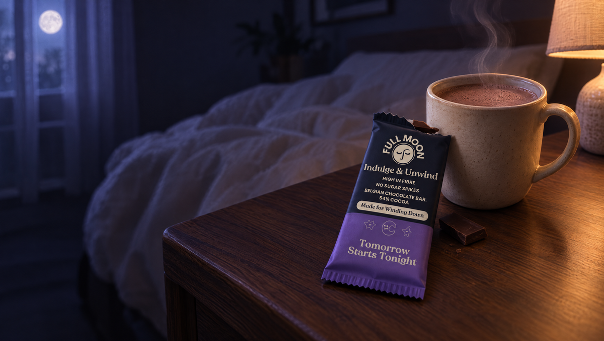 Full Moon chocolate bar and hot cacao on a bedside table in the evening